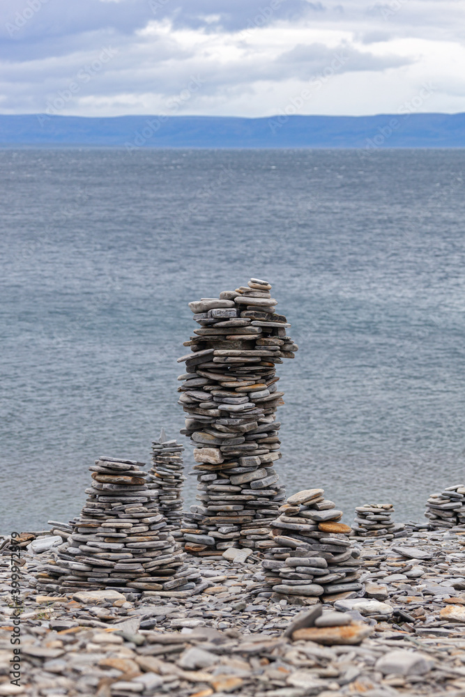 Stone pyramids on the shore of Barents sea in Finnmark, Norway. Havoysund national scenic route. Stone pyramids on the shore of Barents sea in Finnmark, Norway. Havoysund national scenic route.