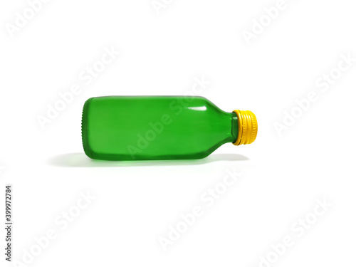 Green glass bottle with yellow lid on white background