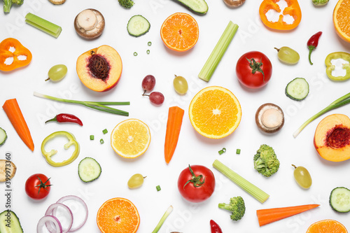 Fresh organic fruits and vegetables on white background, flat lay