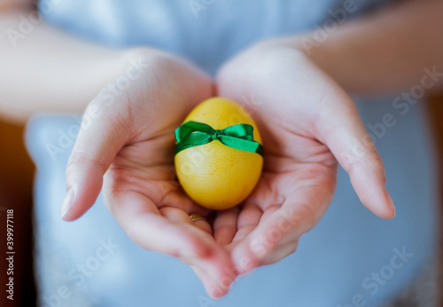 Chicken egg decorated for easter in female hands