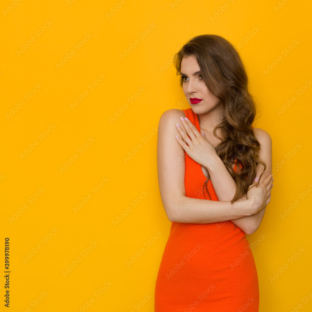 Pensive Young Woman In Tight Orange Dress Pensive Young Woman In Tight Orange Dress
