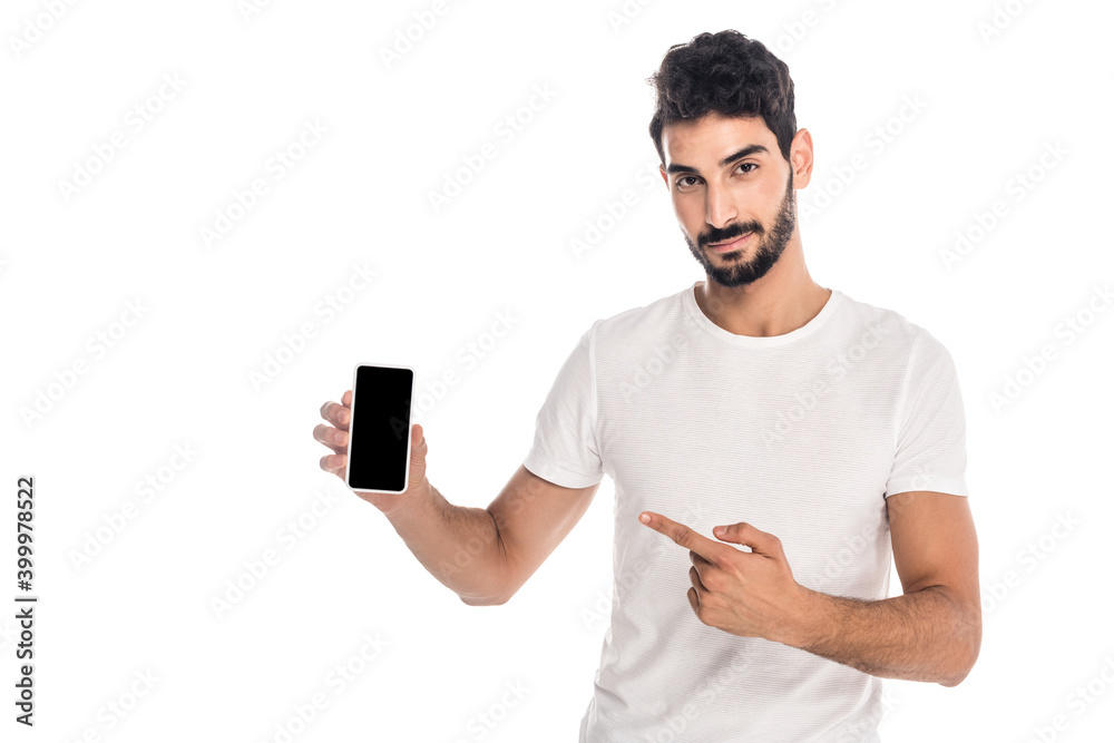 young hispanic man pointing with finger at smartphone with blank screen isolated on white young hispanic man pointing with finger at smartphone with blank screen isolated on white