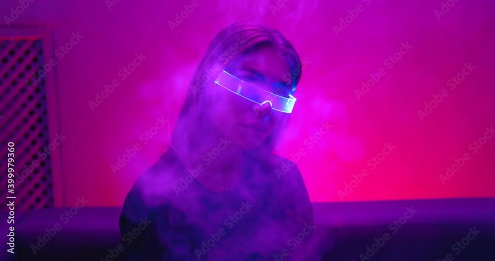 Lots of steam from the vape in the neon room. Cyberpunk style. There is an effect of grain, noise. Lots of steam from the vape in the neon room. Cyberpunk style. There is an effect of grain, noise.