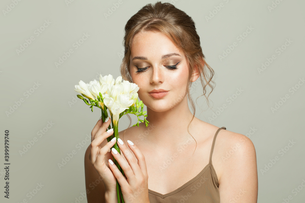 Attractive model woman with healthy clear skin holding white flowers, skincare and facial treatment concept Attractive model woman with healthy clear skin holding white flowers, skincare and facial treatment concept