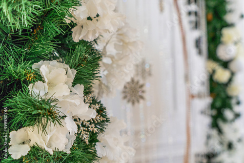 Green Christmas tree with white flowers