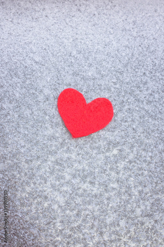 Red felt heart on a frozen window. Red heart on ice. 14 feral  Valentine s Day. Holiday concept  life concept  healthcare  charity  give love