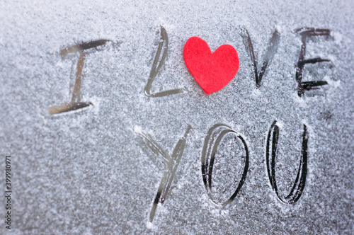 Bild auf Leinwand Valentine's Day concept with red felt heart on snow background