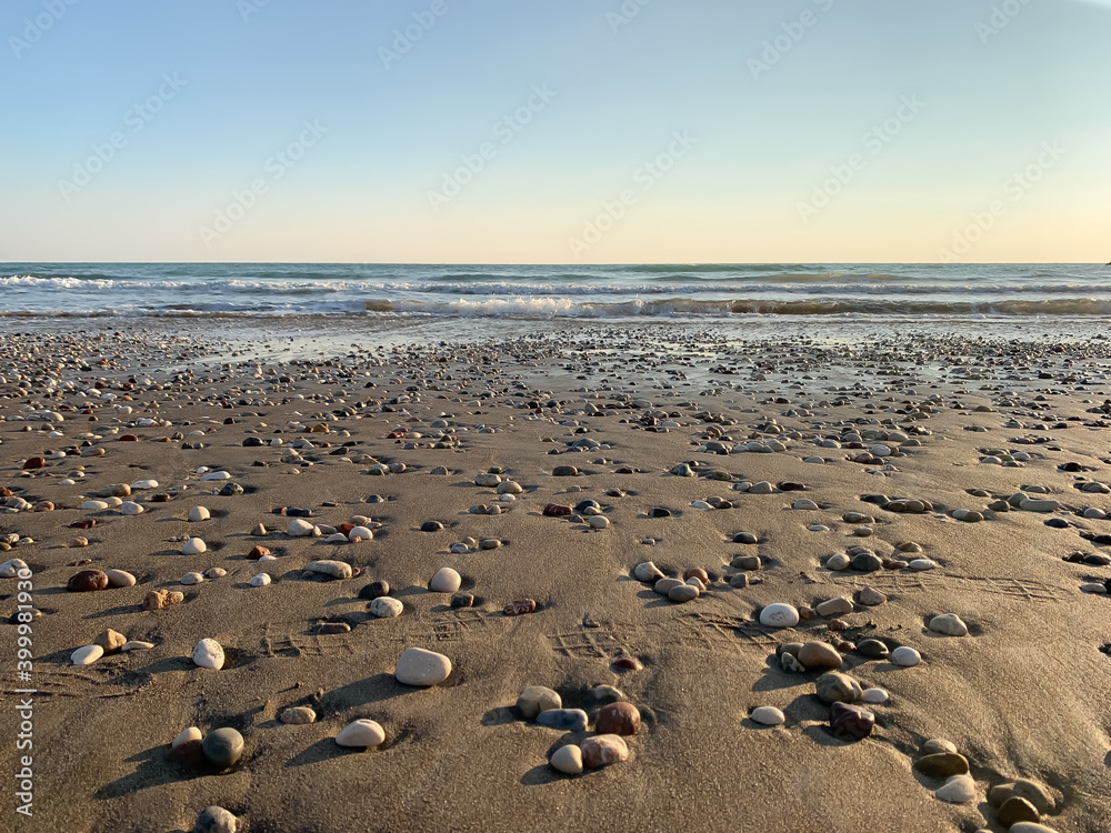Sand beach with some pebbles and se view background Sand beach with some pebbles and se view background