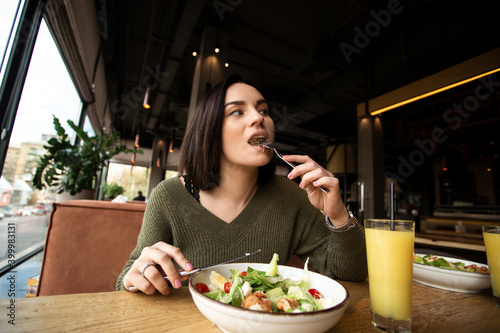 Photography Young woman enjoys tasty meal