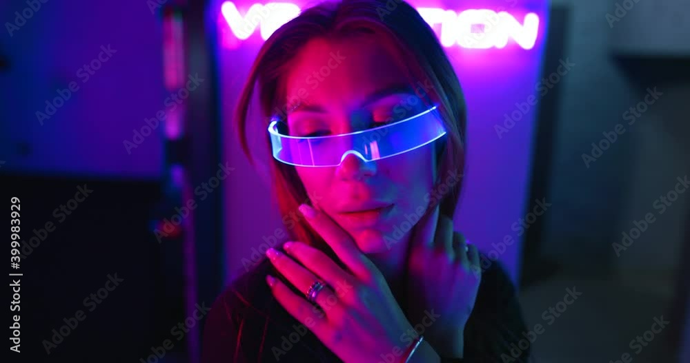 Futuristic neon portrait of a young woman. There is an effect of grain, noise. Futuristic neon portrait of a young woman. There is an effect of grain, noise.