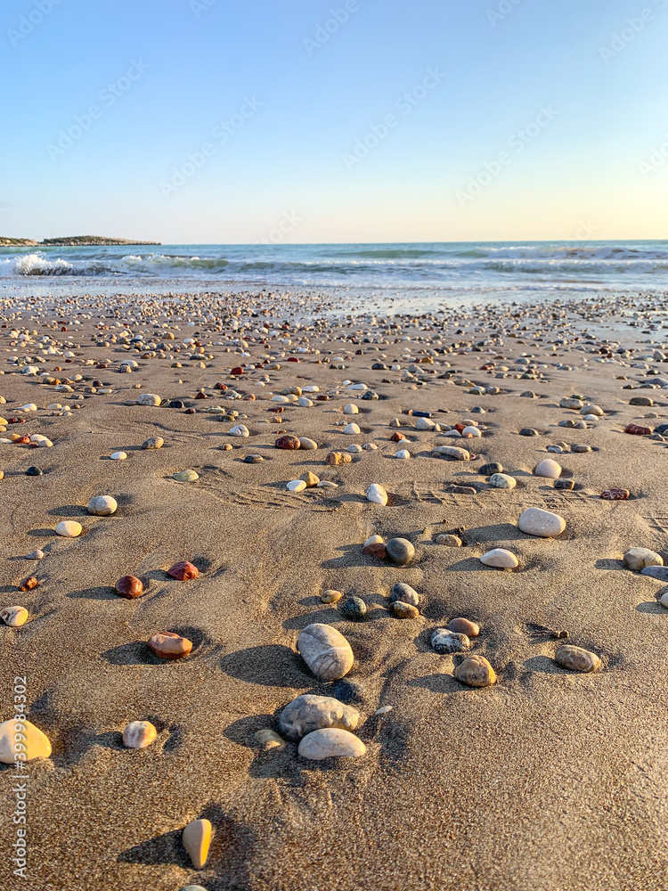 Sand beach with some pebbles and se view background Sand beach with some pebbles and se view background