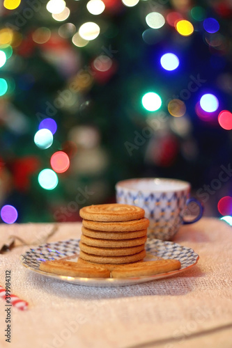 Vintage porcelain dishes, stack of biscuits and Christmas decorations. Selective focus.