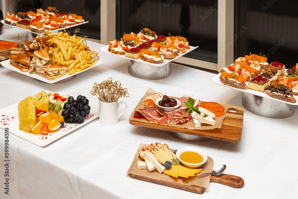 Сatering. Banquet table with different snacks and desserts