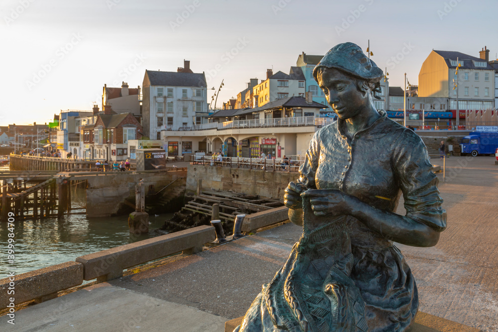 View of the Gansey Girl statue and harbour at sunset, Bridlington, East Yorkshire, England View of the Gansey Girl statue and harbour at sunset, Bridlington, East Yorkshire, England
