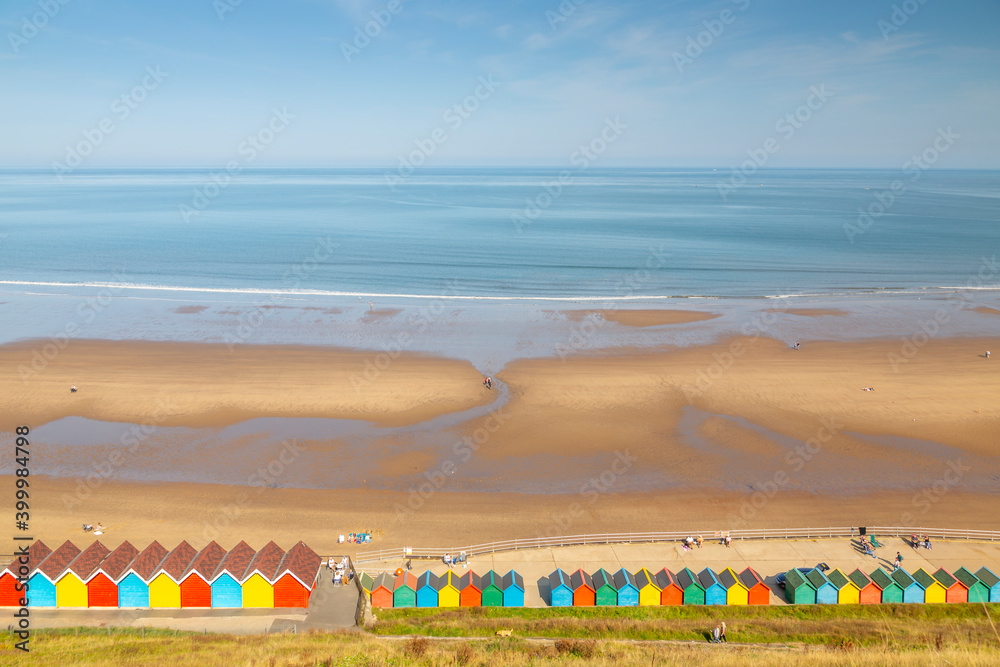 View of colourful beach huts on West Cliff Beach, Whitby, North Yorkshire, England View of colourful beach huts on West Cliff Beach, Whitby, North Yorkshire, England
