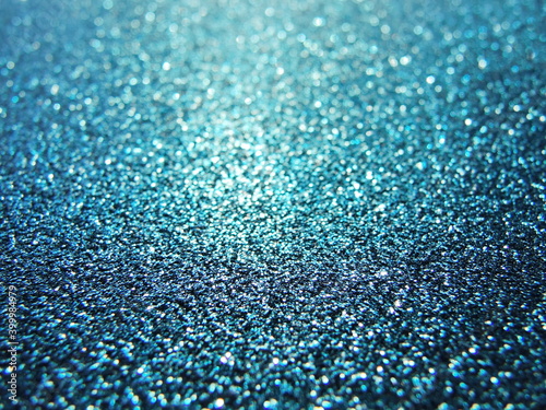 Defocused background of abstract blue and gold glitter lights 