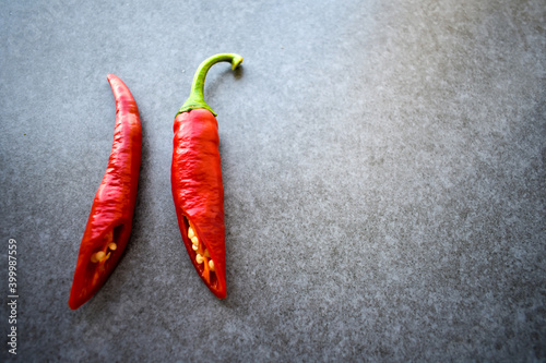 Slice of bright hot chili peppers on table with place for text