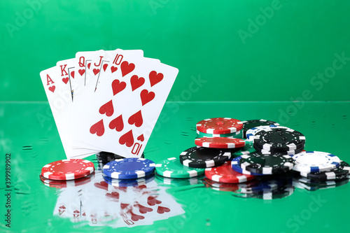 Wallpaper Mural Royal Flush combination under the water drops against green background. Online gambling. Betting. Gambling addiction. Torontodigital.ca