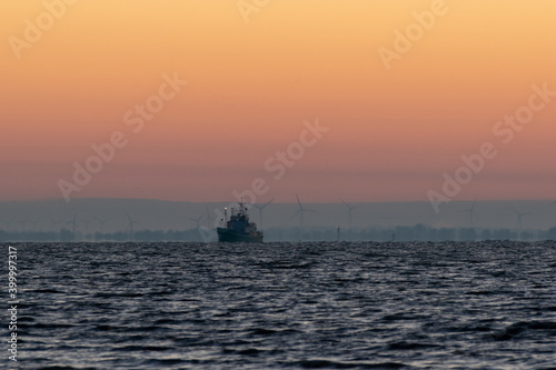 a ship on the sea at sunrise