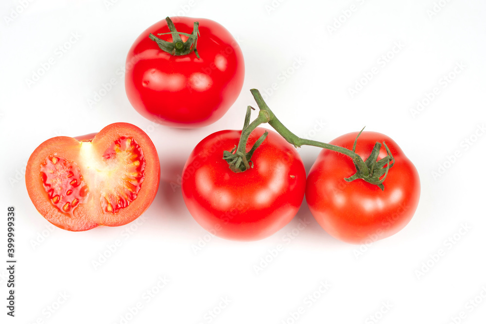 several large red tomatoes and small slices close-up several large red tomatoes and small slices close-up