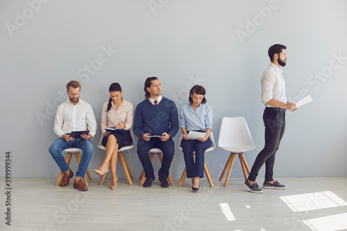 Fotografía Job candidate stands up and goes to HR manager's office while other applicants a