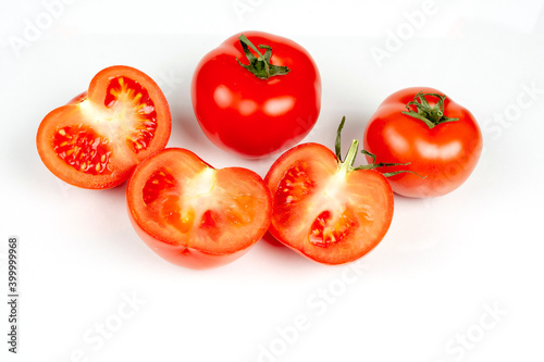 several large red tomatoes close-up on a white background