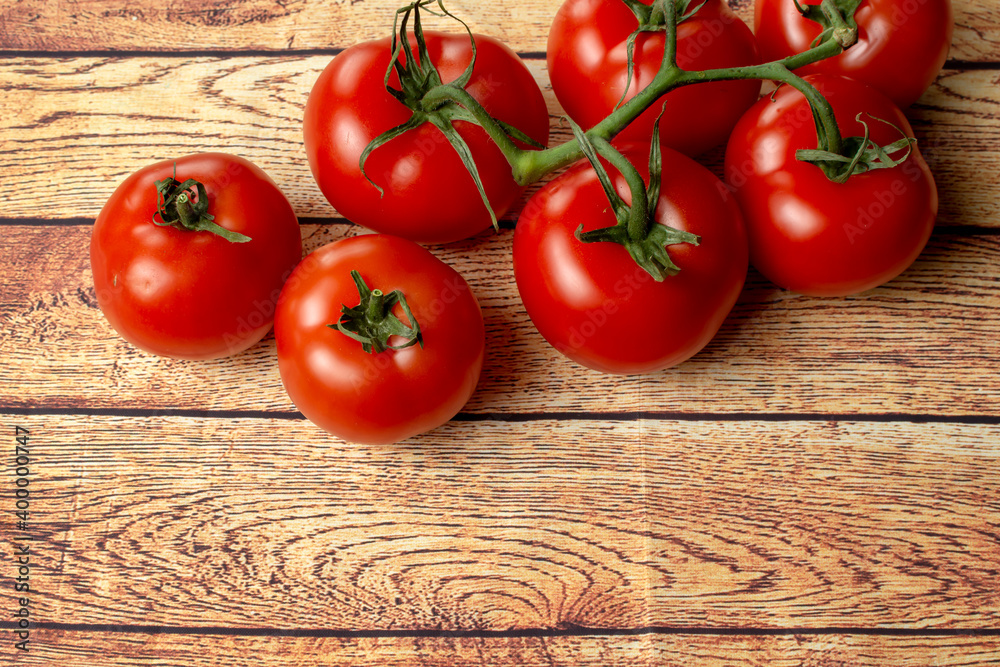 large red tomatoes on a branch close-up large red tomatoes on a branch close-up
