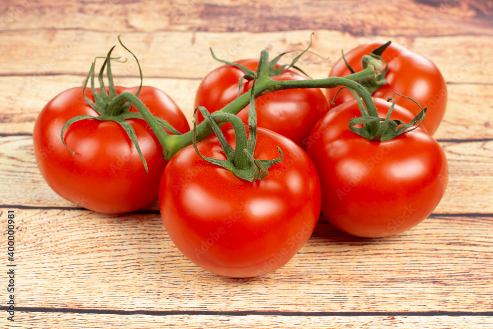 several ripe red tomatoes on a wooden table several ripe red tomatoes on a wooden table