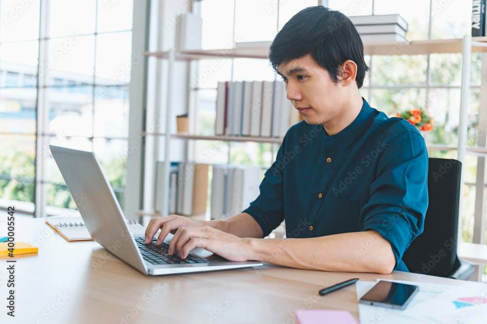 businessman using laptop on desk in office businessman using laptop on desk in office