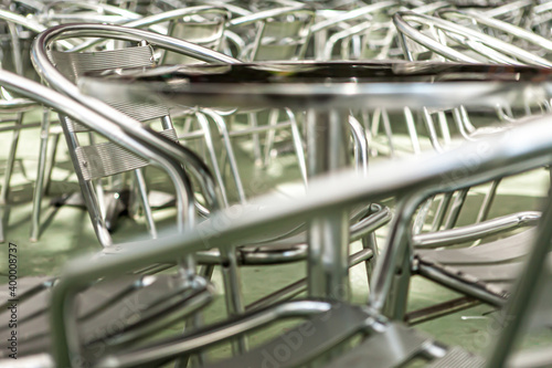 Abstract aluminium chairs and tables in outdroor cafe and resturant. Soft focus for selective focus. Close up, copy space.