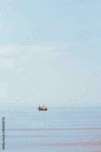 Fisherman boats on the sea. Clean background. Vintage hight key style for copy space.