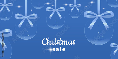 Christmas sale horizontal banner. Transparent Christmas balls with snow, and bows. Advertising background with new year decoration, and space for text. Winter holidays discounts, specials offers.