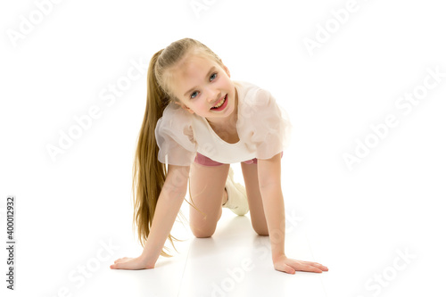 The little girl is on her knees.