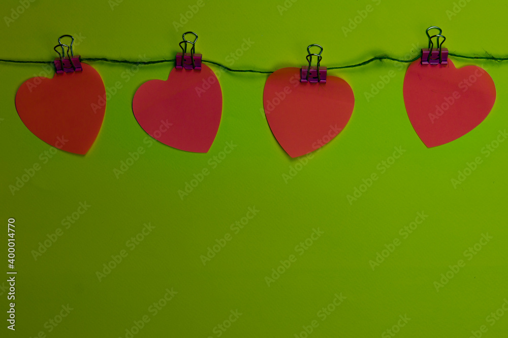 Pink hearts on a green background. Valentine's day concept