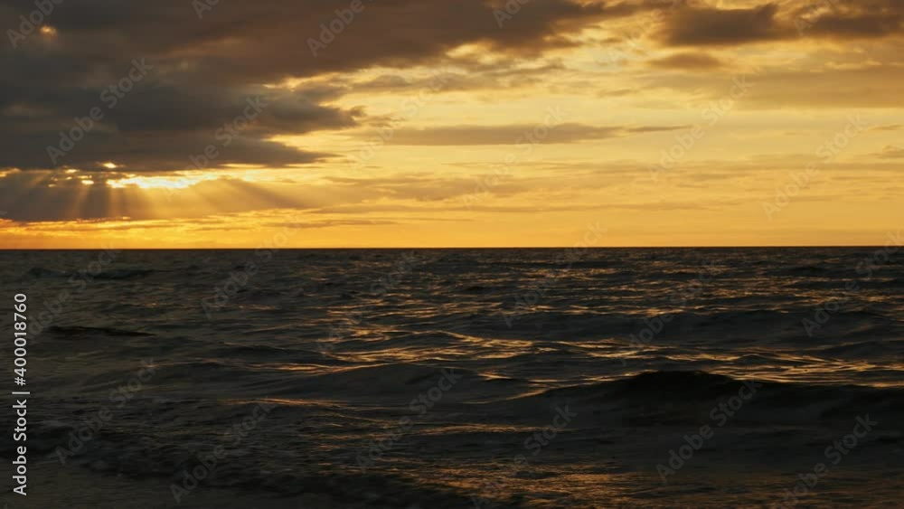 Waving sea and sun beyond the clouds above the sea. Waving sea and sun beyond the clouds above the sea.