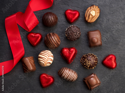 Chocolate candy with red ribbon, top view, flat lay photo