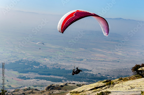 Paraglider taking off from a mountain photo