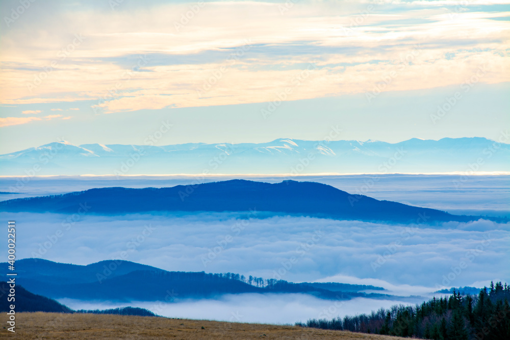 landscape with a sea of fog in the valley seen from the mountain landscape with a sea of fog in the valley seen from the mountain