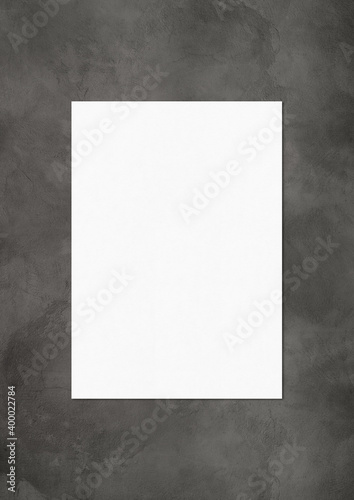 Blank White A4 paper sheet mockup template on dark concrete background © daboost
