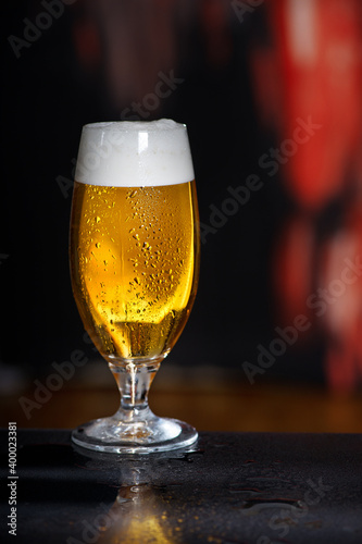 Glass of beer on the dark background