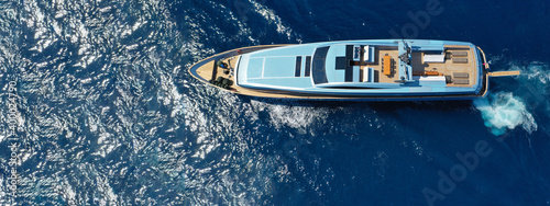 Aerial drone top down ultra wide photo of luxury yacht cruising in low speed in Mediterranean deep blue sea © aerial-drone