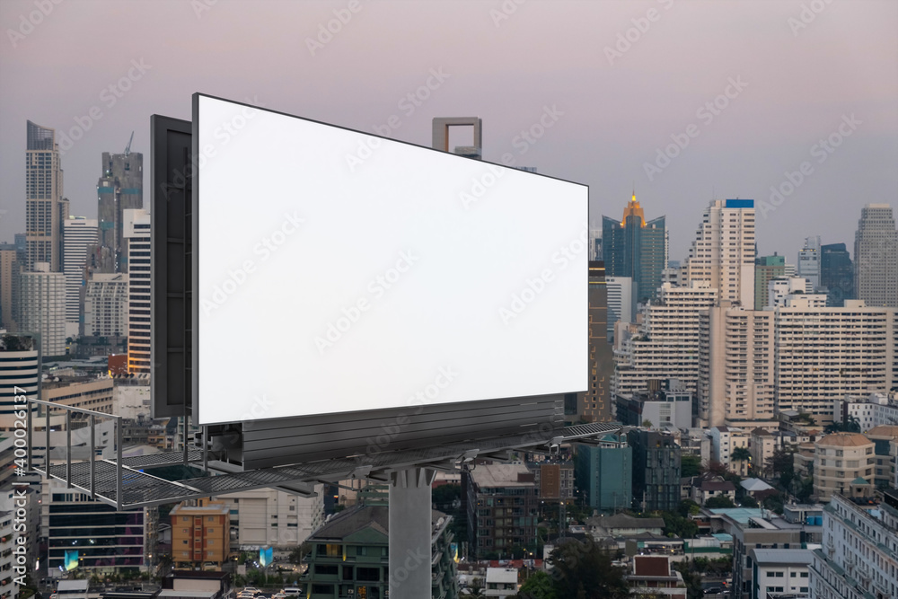 Blank white road billboard with Bangkok cityscape background at sunset. Street advertising poster, mock up, 3D rendering. Side view. The concept of marketing communication to promote or sell idea. Blank white road billboard with Bangkok cityscape background at sunset. Street advertising poster, mock up, 3D rendering. Side view. The concept of marketing communication to promote or sell idea.