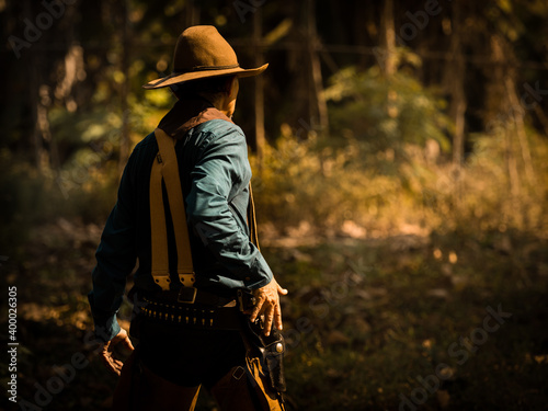 Photos The senior cowboy stands preparing for a gunfight against opponents in the outla