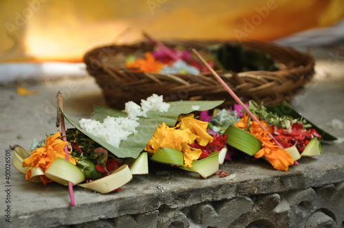 Ritual and beliefs:  colorful flower basket, incense, bananaleaf and rice as a hindu offering on Bali 