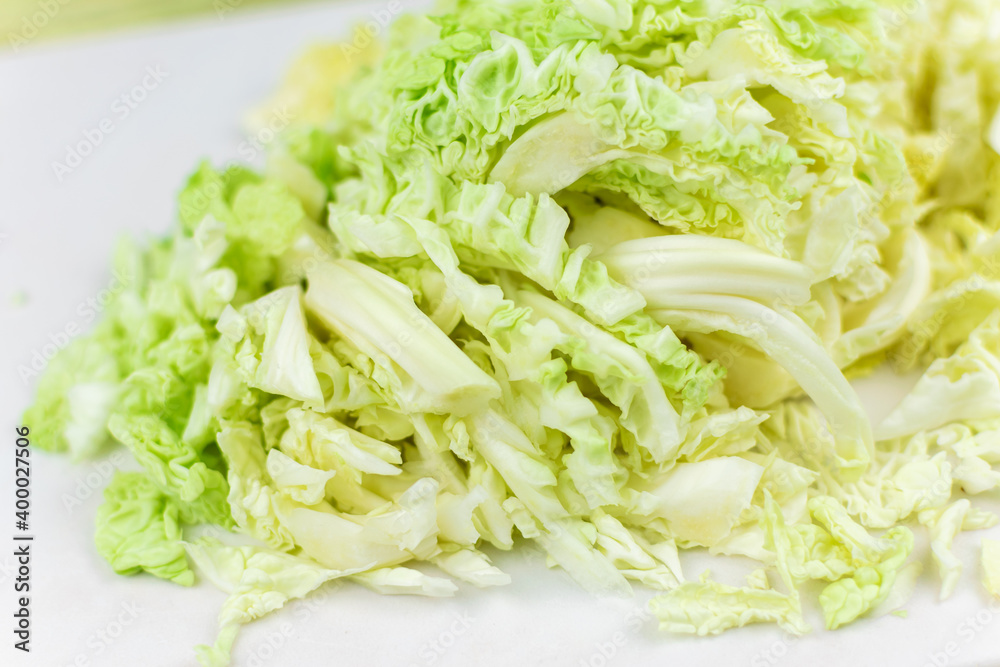 Shredded white cabbage on a white board. Shredded white cabbage on a white board.