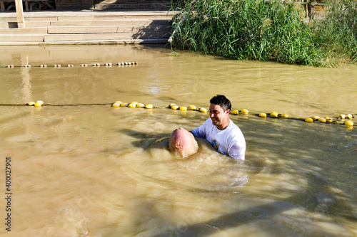 Fotobehang a man toes underwater at his baptism in the Jordan River