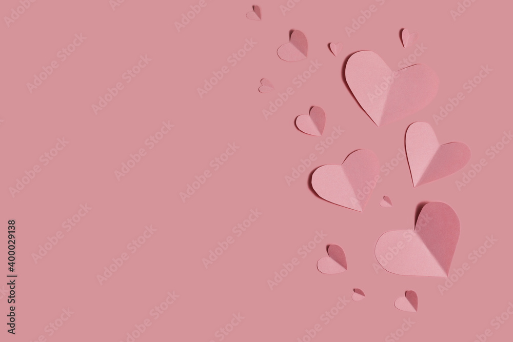 pink paper hearts on a pink background. congratulations on Valentine's Day. flat lay, copy space