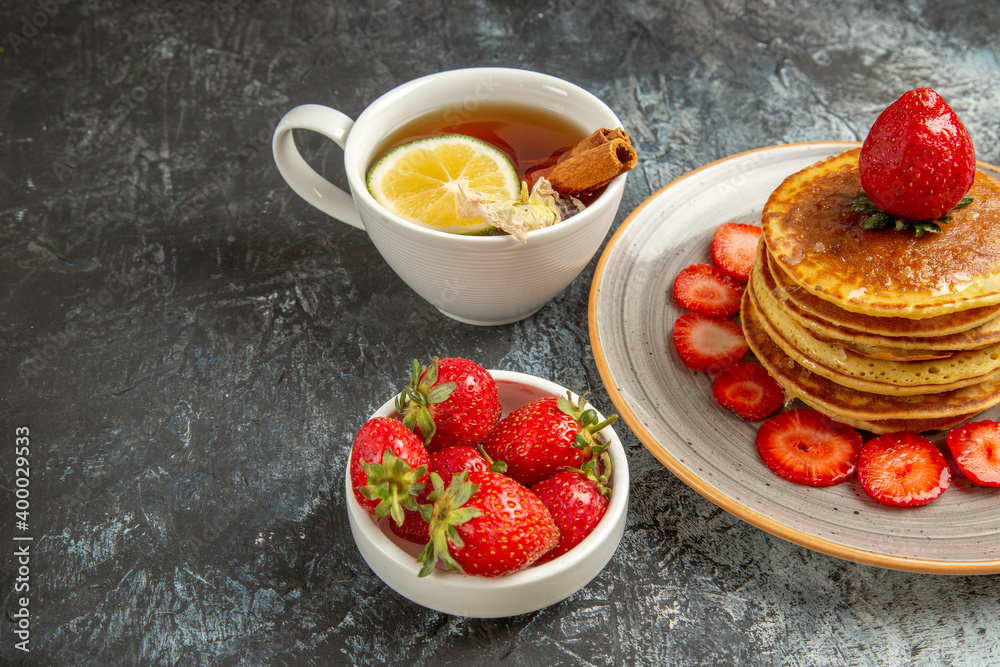 front view yummy pancakes with tea and fruits on light background fruit cake sweet front view yummy pancakes with tea and fruits on light background fruit cake sweet