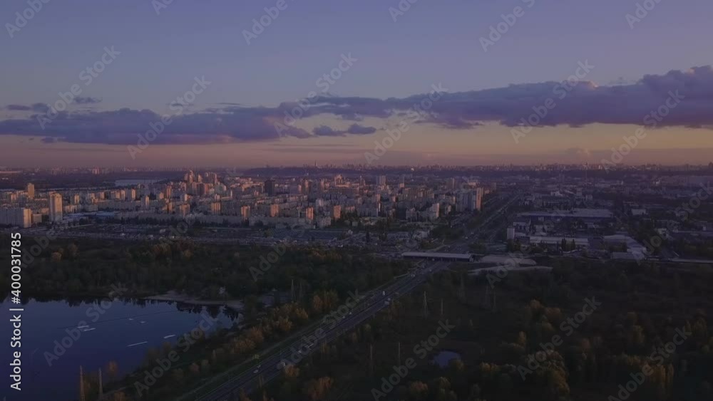 Flight over the lake during sunset overlooking the city with beautiful clouds, Ukraine Kiev. Flight over the lake during sunset overlooking the city with beautiful clouds, Ukraine Kiev.