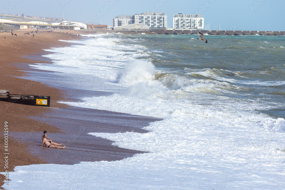Naklejka premium sitting sunbathing by the sea in Brighton